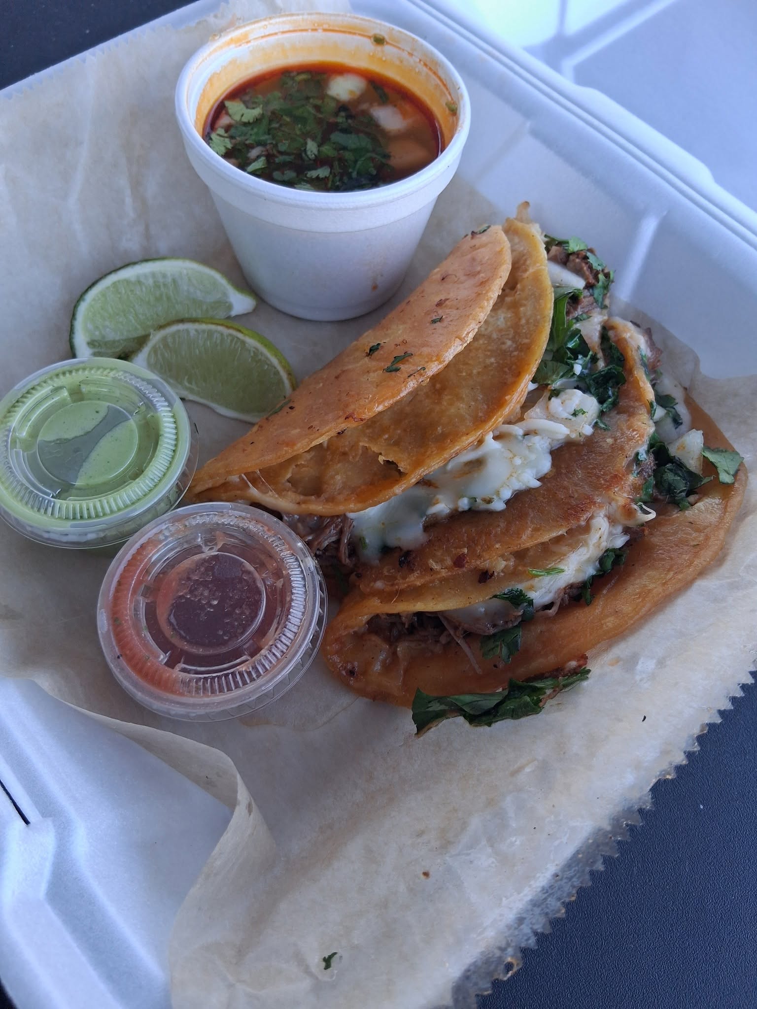 Tinoco birria tacos with melted cheese, cilantro, lime, salsa and consommé