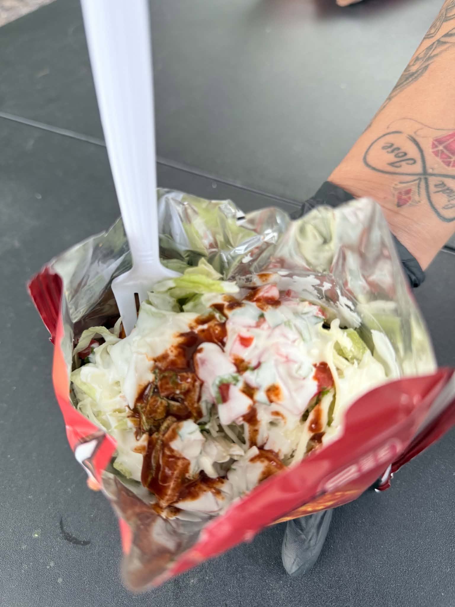 Tinoco walking taco special with lettuce, cheese and toppings